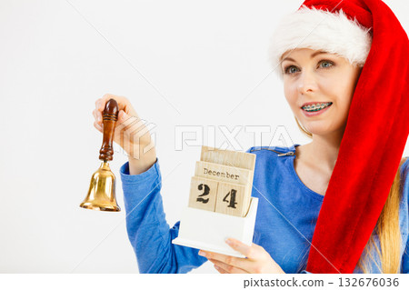 Woman and christmas calendar with bell Woman and christmas calendar with bell 132676036
