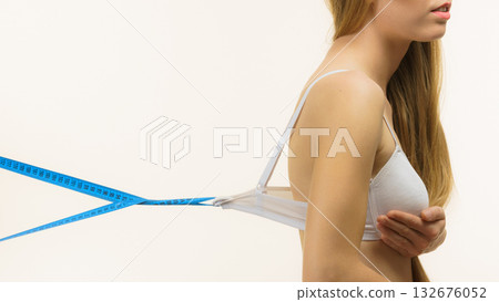 Woman wearing too big bra, loose band Woman wearing too big bra, loose band 132676052