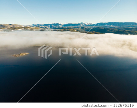 Clouds over lake water, Hardangervidda landscape, Norway 132676119