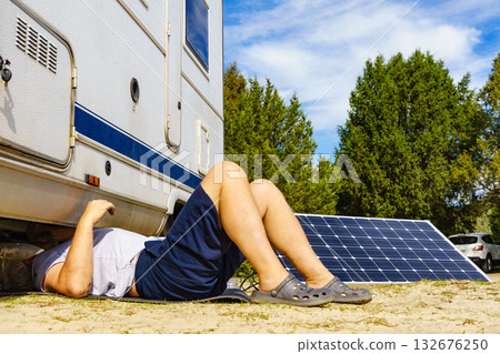 Man repairing bottom of the rv caravan Man repairing bottom of the rv caravan 132676250
