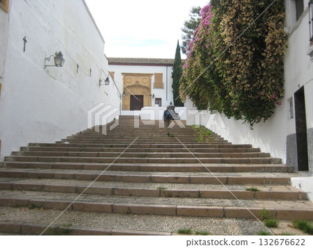 Cobblestone stairs surrounded by white walls in the Jewish Quarter of Cordoba Cobblestone stairs surrounded by white walls in the Jewish Quarter of Cordoba 132676622