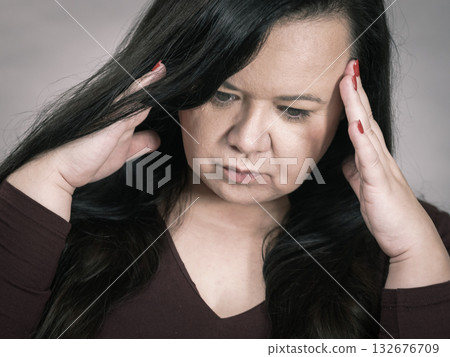 Worried woman having painfull headache 132676709