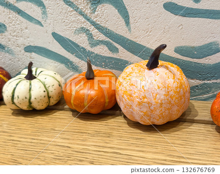 Decorative pumpkins on wooden surface. Autumn still life, seasonal decor, and cozy fall home inspiration. 132676769
