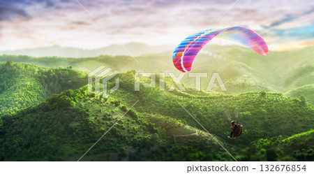 Paragliding multicolor. Paraglider flying over Landscape from the background Beauty nature mountain landscape of the sky. 132676854