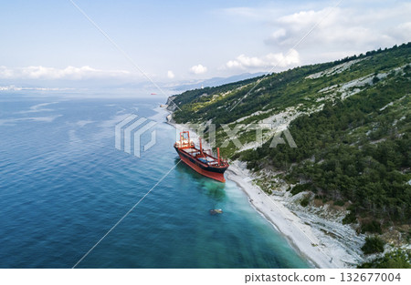 Aerial view of an abandoned bulk-carrier dry cargo ship washed ashore after a storm 132677004