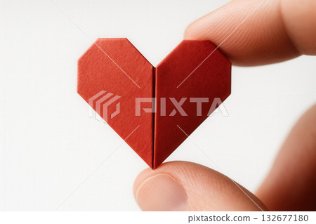 Origami Red Heart Between Fingers 132677180