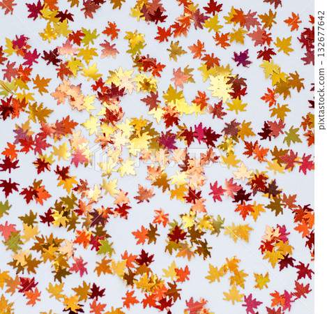 Autumn maple leaf confetti in gold and red for festive celebration and fall decor Autumn maple leaf confetti in gold and red for festive celebration and fall decor 132677642