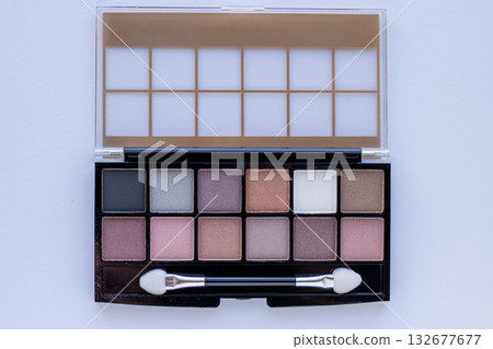 Eyeshadow palette with twelve shades and applicator brush in sleek black case Eyeshadow palette with twelve shades and applicator brush in sleek black case 132677677