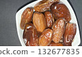 Close-up of dried dates in a white bowl. Healthy, natural food. 132677835