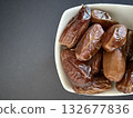 Close-up of dried dates in a white bowl. Healthy, natural food. 132677836