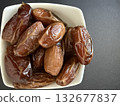 Close-up of dried dates in a white bowl. Healthy, natural food. 132677837