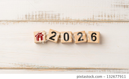 Red House Icon and Wooden Blocks Forming 2026 on White Wooden Surface for Real Estate and Home Planning 132677911