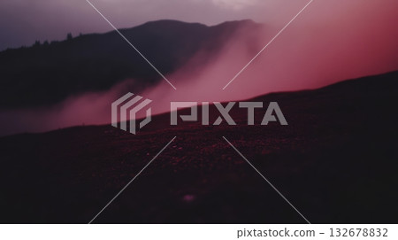 Misty landscape at dusk with pink and purple hues 132678832