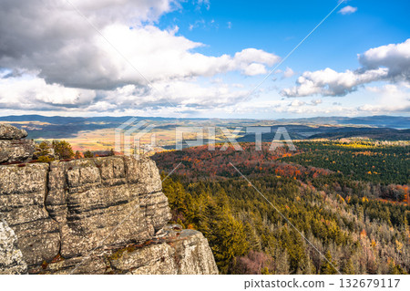 Journey to the Southern Terraces in Stolowe Mountains National Park, Poland, to enjoy stunning panoramic views surrounded by vibrant autumn colors and unique sandstone formations. 132679117