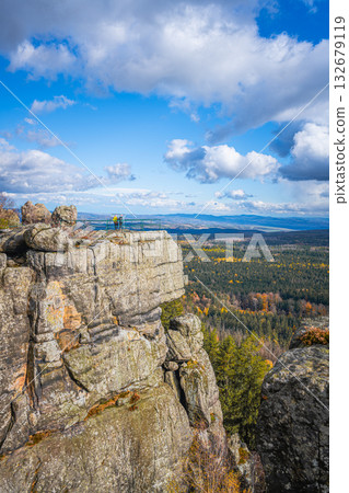 Visitors enjoy the breathtaking views from the lookout point at Southern Terraces in Stolowe Mountains National Park during autumn. 132679119