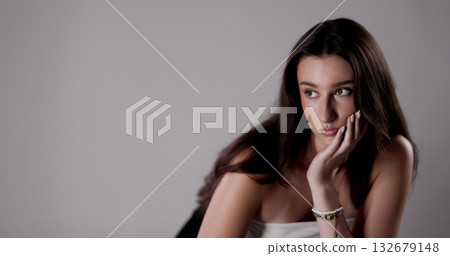 Fashion model posing with hand on face looking away from camera Fashion model posing with hand on face looking away from camera 132679148