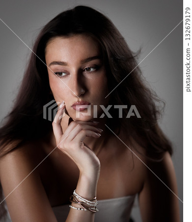 Fashion model posing with hand on chin, thinking and looking away 132679179