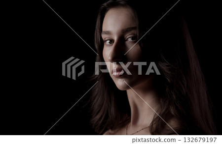 Fashion model posing in studio with black background 132679197