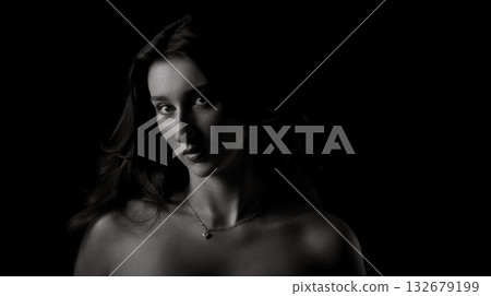 Fashion model posing in low key black and white portrait Fashion model posing in low key black and white portrait 132679199