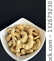 Close-up of dried cashews in a white bowl. Healthy, natural food. 132679230