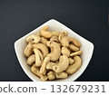 Close-up of dried cashews in a white bowl. Healthy, natural food. 132679231