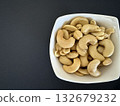 Close-up of dried cashews in a white bowl. Healthy, natural food. 132679232