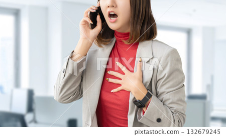 A woman/businesswoman surprised while talking on her smartphone 132679245