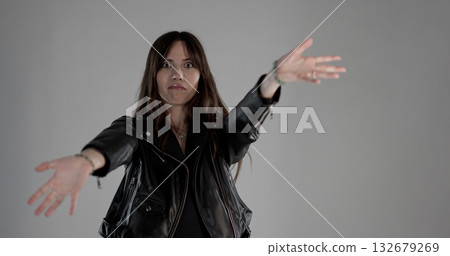 Fashion model reaching out her hands with a funny expression Fashion model reaching out her hands with a funny expression 132679269