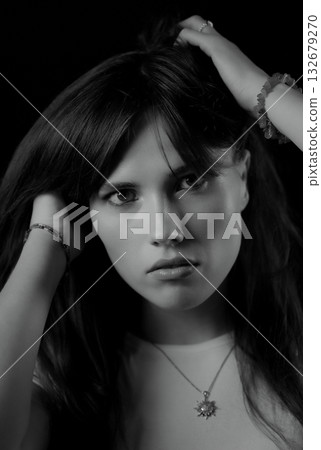 Fashion model playing with her hair in black and white Fashion model playing with her hair in black and white 132679270