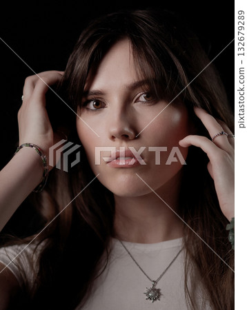 Fashion model touching her hair and wearing a necklace 132679289