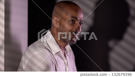 Confident African American businessman looking away in office Confident African American businessman looking away in office 132679396