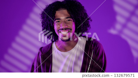 Young african-american man with curly hair smiling on purple background Young african-american man with curly hair smiling on purple background 132679571