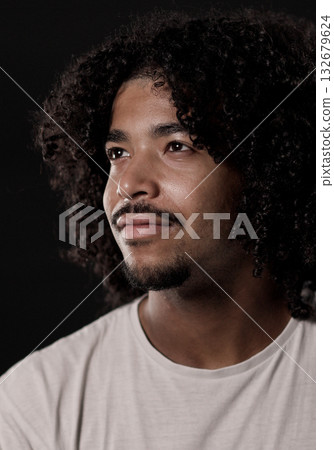 Young african-american man with curly hair looking up and smiling Young african-american man with curly hair looking up and smiling 132679624
