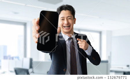 Male businessman showing smartphone screen Male businessman showing smartphone screen 132679771