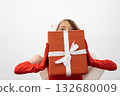 A joyful character in colorful festive attire holds a beautifully wrapped gift, embodying the spirit of celebration and holiday cheer, perfect for seasonal promotions and gatherings 132680009