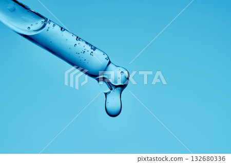 Gel hyaluronic serum in a pipette on a blue background. 132680336