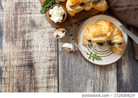 Freshly baked croissants with mushrooms and ricotta on rustic wooden table setting. Top view flat lay. Freshly baked croissants with mushrooms and ricotta on rustic wooden table setting. Top view flat lay. 132680629
