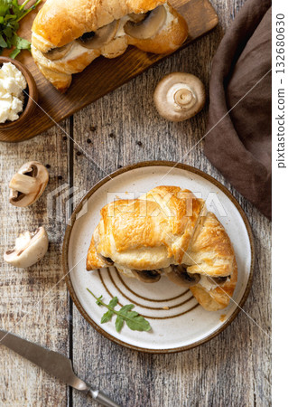 Freshly baked croissants with mushrooms and ricotta on rustic wooden table setting. Top view flat lay. Freshly baked croissants with mushrooms and ricotta on rustic wooden table setting. Top view flat lay. 132680630