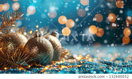 Glittering Christmas ornaments with golden bokeh lights on a blue festive backdrop 132680852