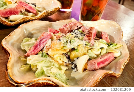 A plate of food with meat and lettuce 132681209