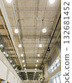 perspective view of exposed air ducts and electrical systems on bare concrete ceiling in modern building. 132681452