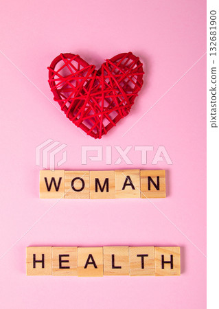 Wooden lettering and red heart on pink background. Womens health concept. 132681900