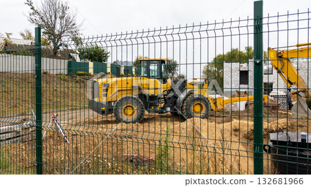 Orange bulldozer at a construction site on a cloudy day. Construction equipment moves sand Orange bulldozer at a construction site on a cloudy day. Construction equipment moves sand 132681966
