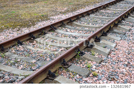 Empty railroad track under a blue sky, from left to right. Railroad lines. Close-up of railroad tracks, metal rails, railroad track. Empty railroad track under a blue sky, from left to right. Railroad lines. Close-up of railroad tracks, metal rails, railroad track. 132681967
