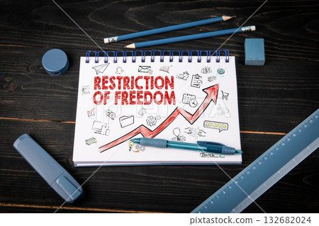 Notebook with text Restriction Of Freedom and upward arrow surrounded by business icons Notebook with text Restriction Of Freedom and upward arrow surrounded by business icons 132682024