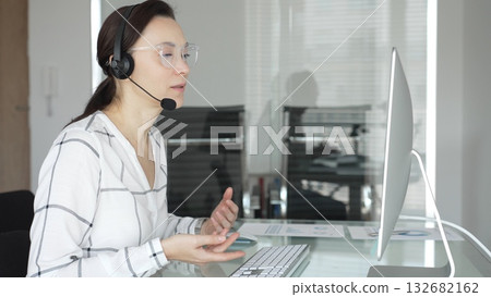 Woman consultant interacting on video call, providing online customer support service in modern office. Business people concept Woman consultant interacting on video call, providing online customer support service in modern office. Business people concept 132682162