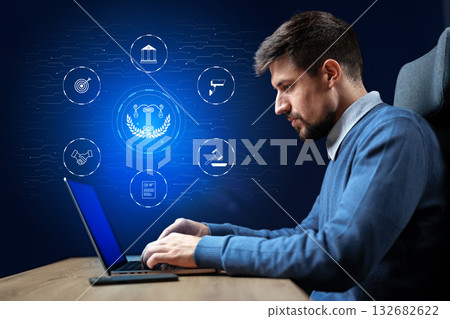 Professional man working on laptop with digital icons representing law and technology concepts 132682622