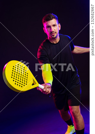 Competitive player demonstrates skillful paddle movement in indoor setting 132682667