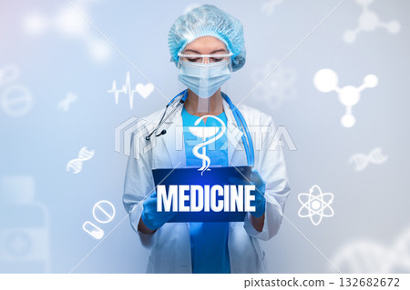Medical professional wearing protective gear holds sign with medicine symbol in modern setting 132682672