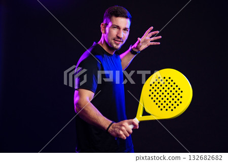 Player prepares to serve during an intense paddle tennis match in a sports studio 132682682